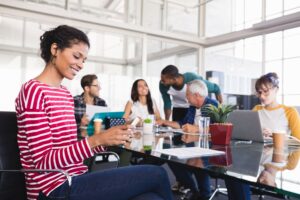 woman smiling looking at her phone