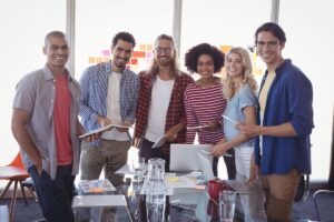 MBA teams standing at conference table